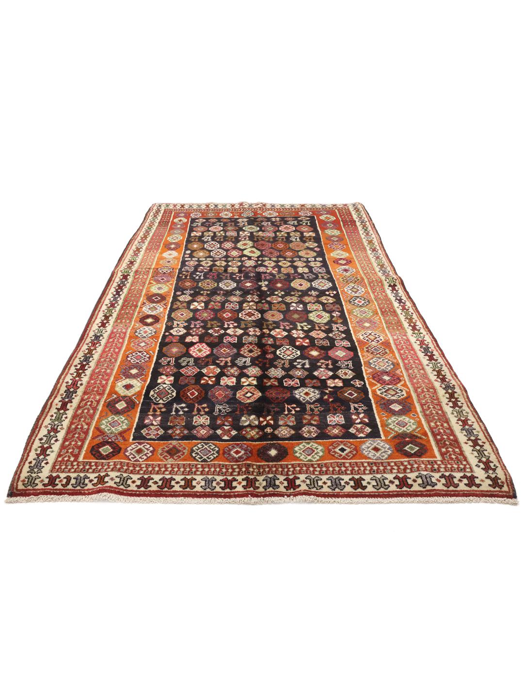 Hand-knotted Ghashghai rug from the Middle East with a dark blue and red colour palette