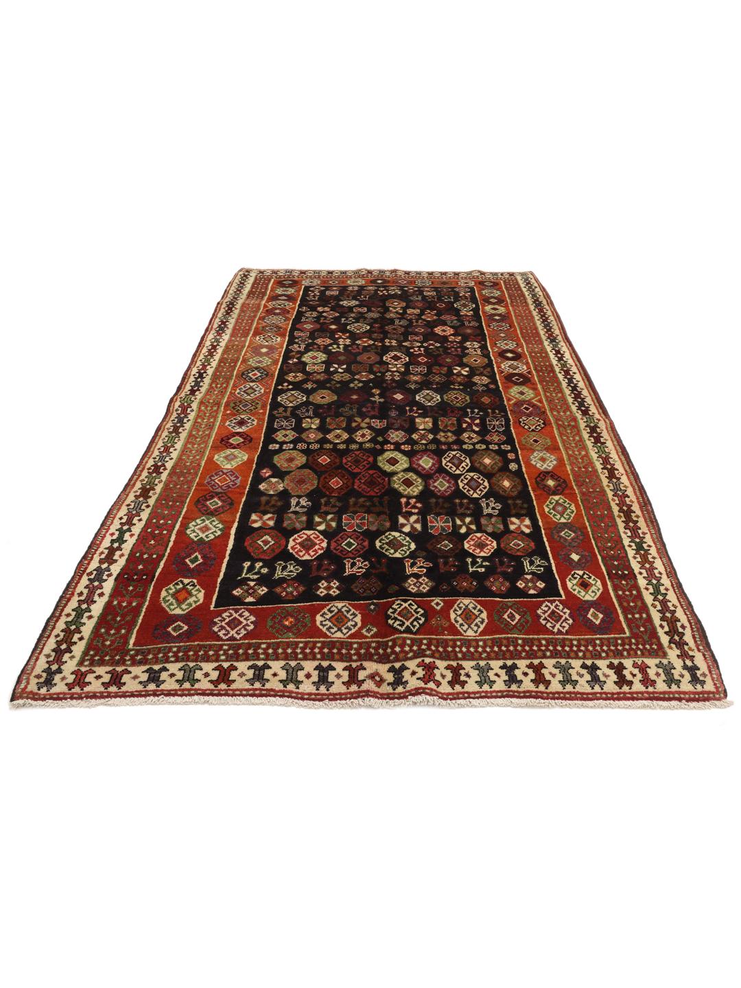 Hand-knotted Ghashghai rug from the Middle East with a dark blue and red colour palette