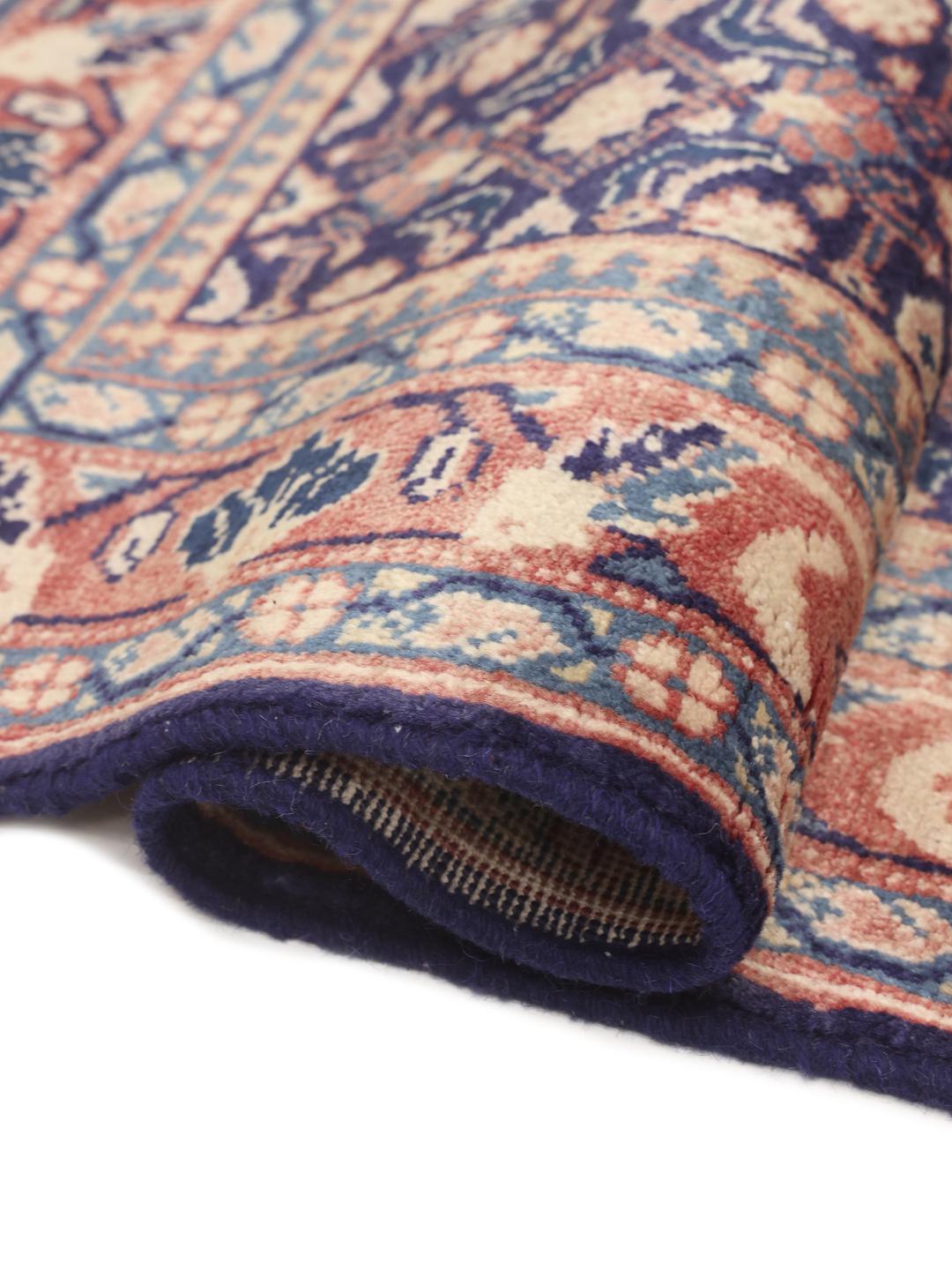 A hand-knotted Sarough rug from the Middle East with a deep blue floral pattern