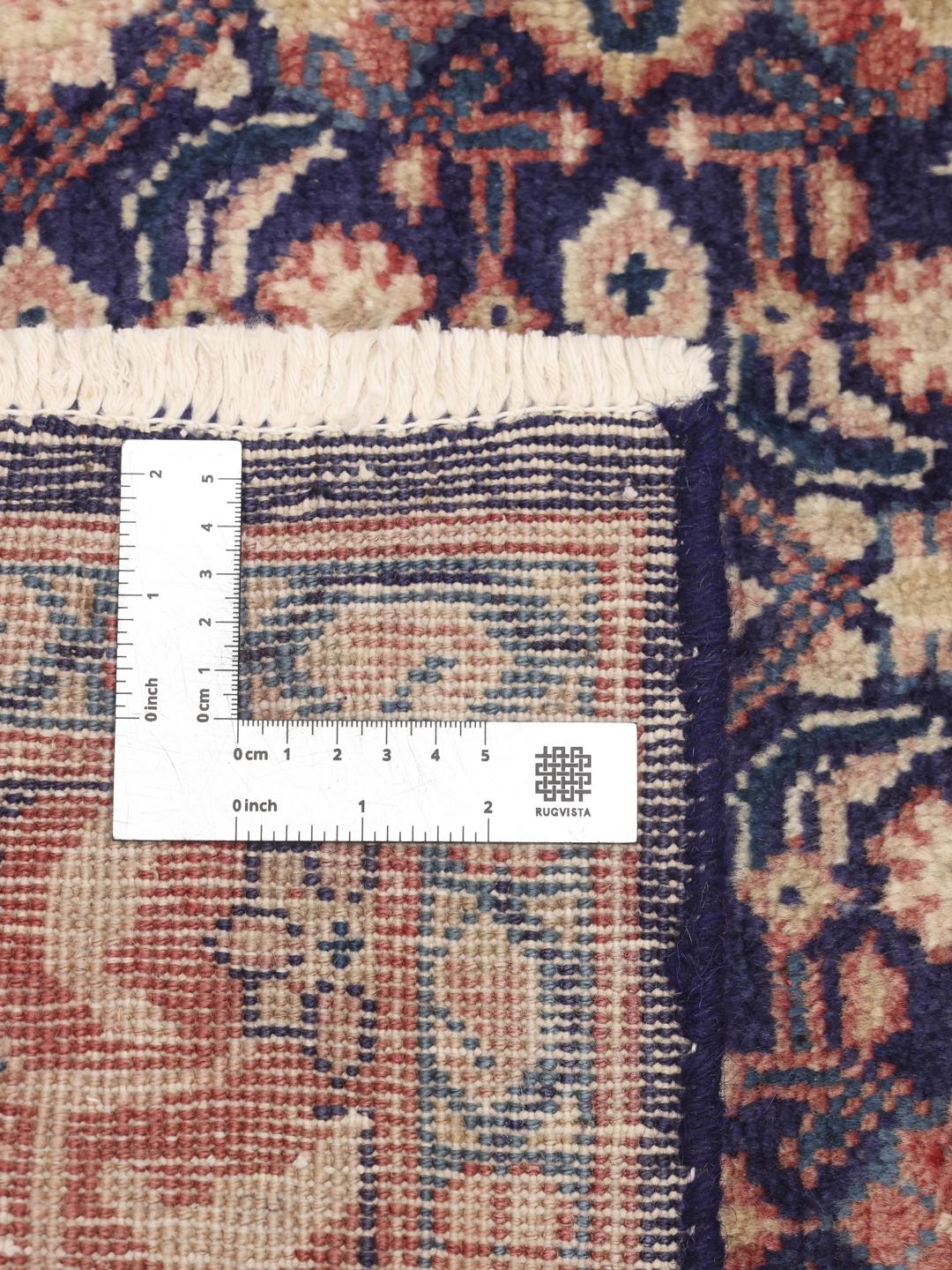 A hand-knotted Sarough rug from the Middle East with a deep blue floral pattern
