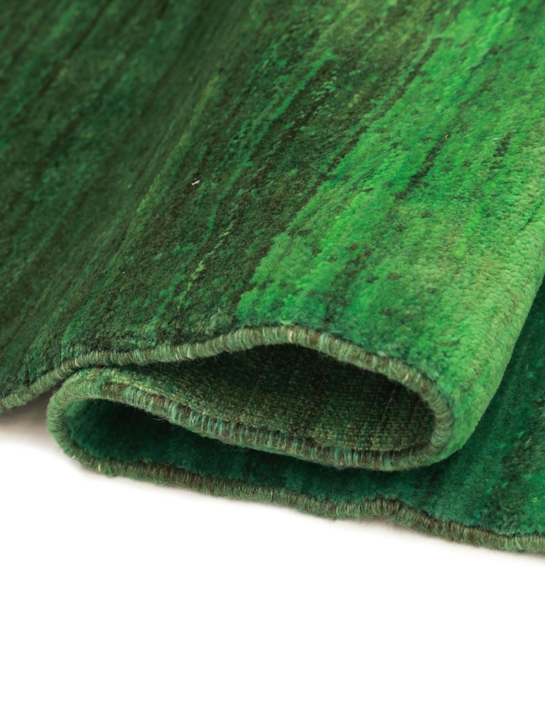 A hand-knotted green Gabbeh rug from the Middle East with a subtle ombre design.