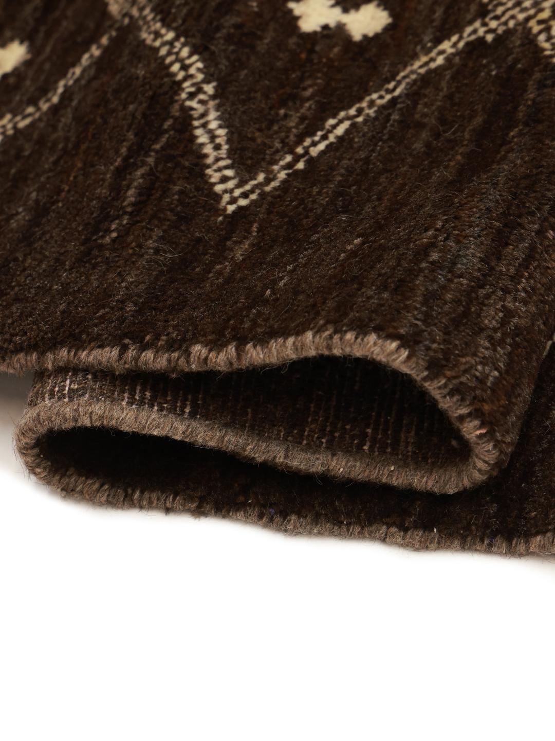 A hand-knotted brown wool rug with a geometric grid pattern from the Middle East.