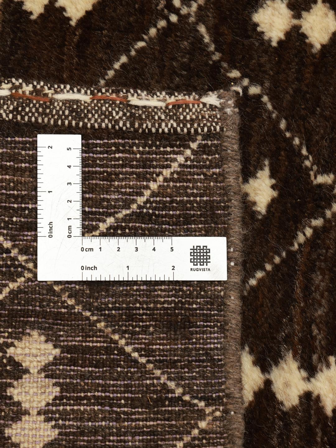 A hand-knotted brown wool rug with a geometric grid pattern from the Middle East.