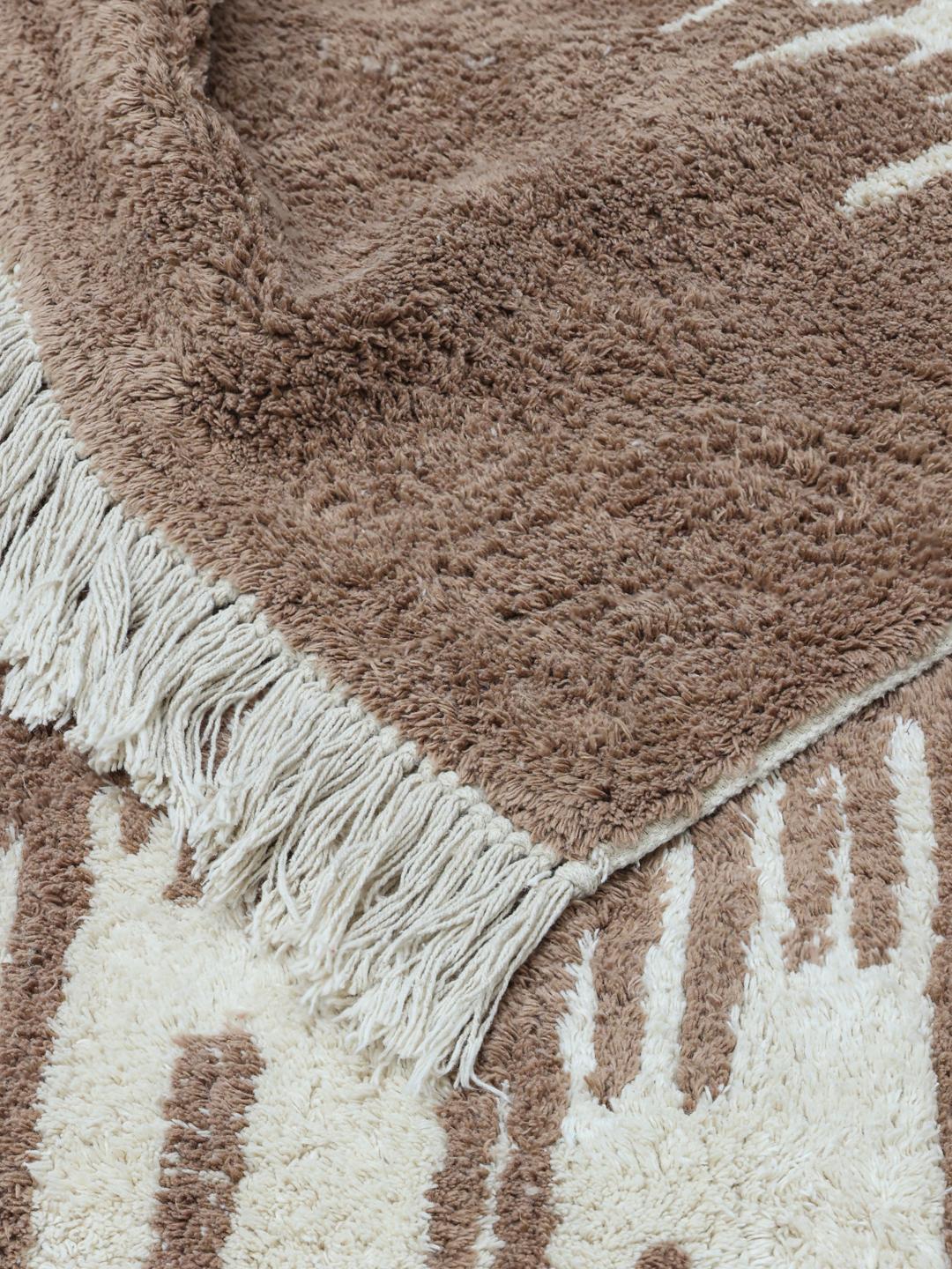 Beige en wit tapijt met organisch patroon en franjes
