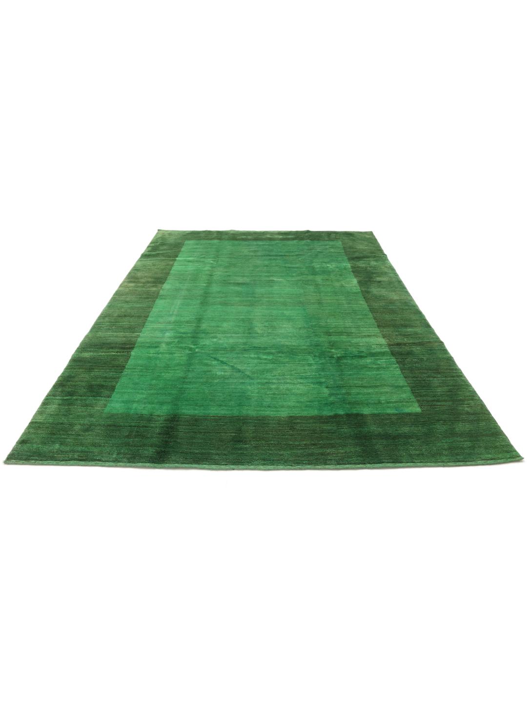 Hand-knotted Gabbeh rug from the Middle East in a deep green shade.