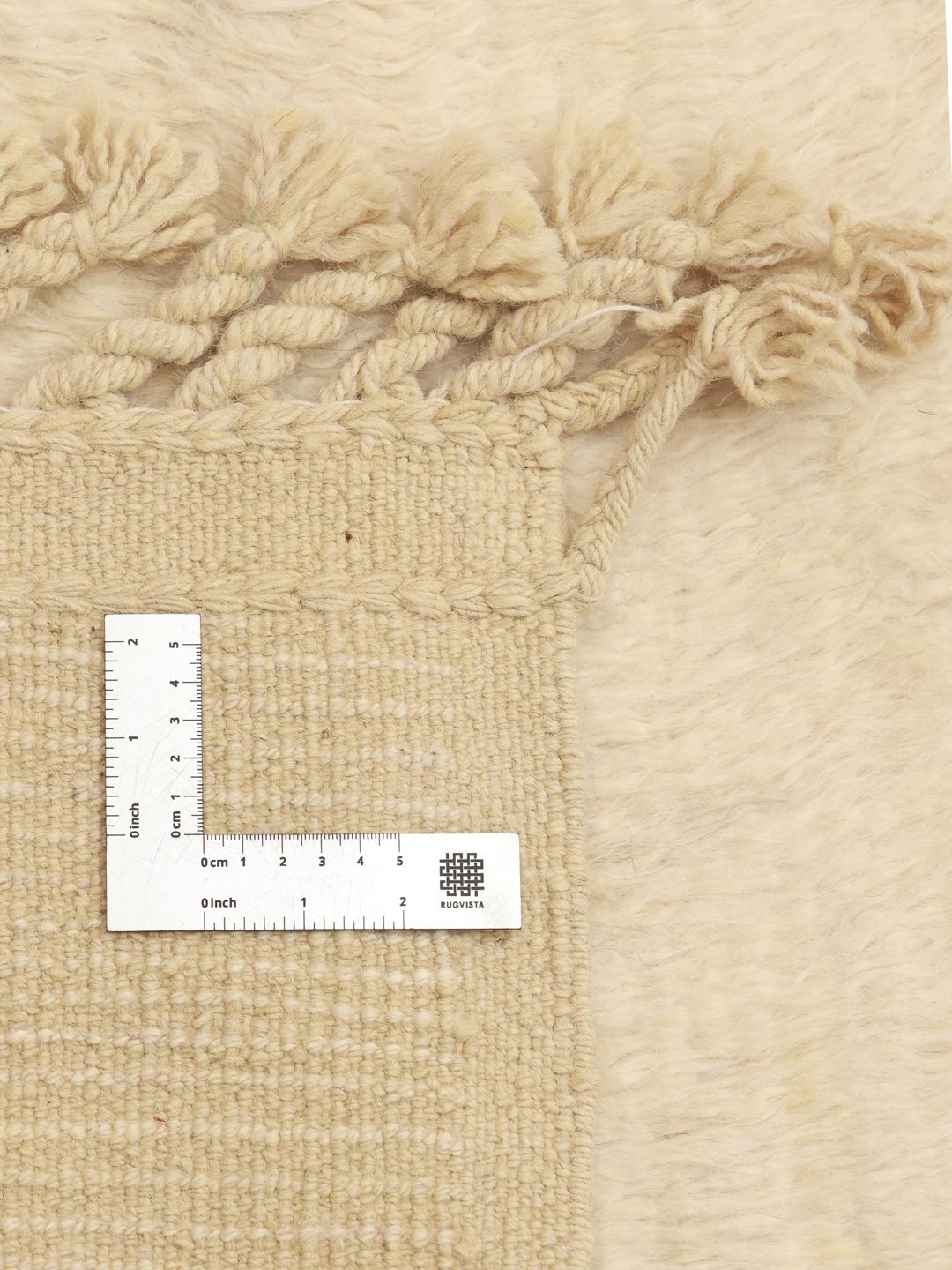 A neutral, hand-knotted beige rug from Afghanistan with an organic, minimalist design.
