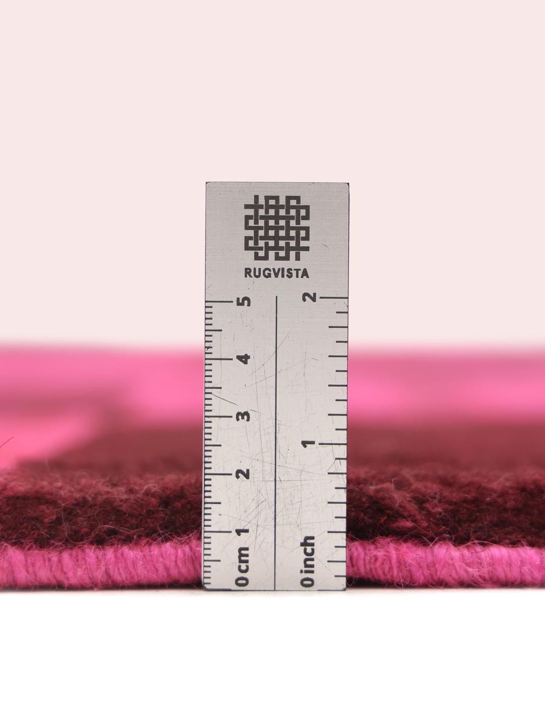Et håndknyttet Gabbeh tæppe fra Mellemøsten med et levende skakternet mønster i pink og brun.