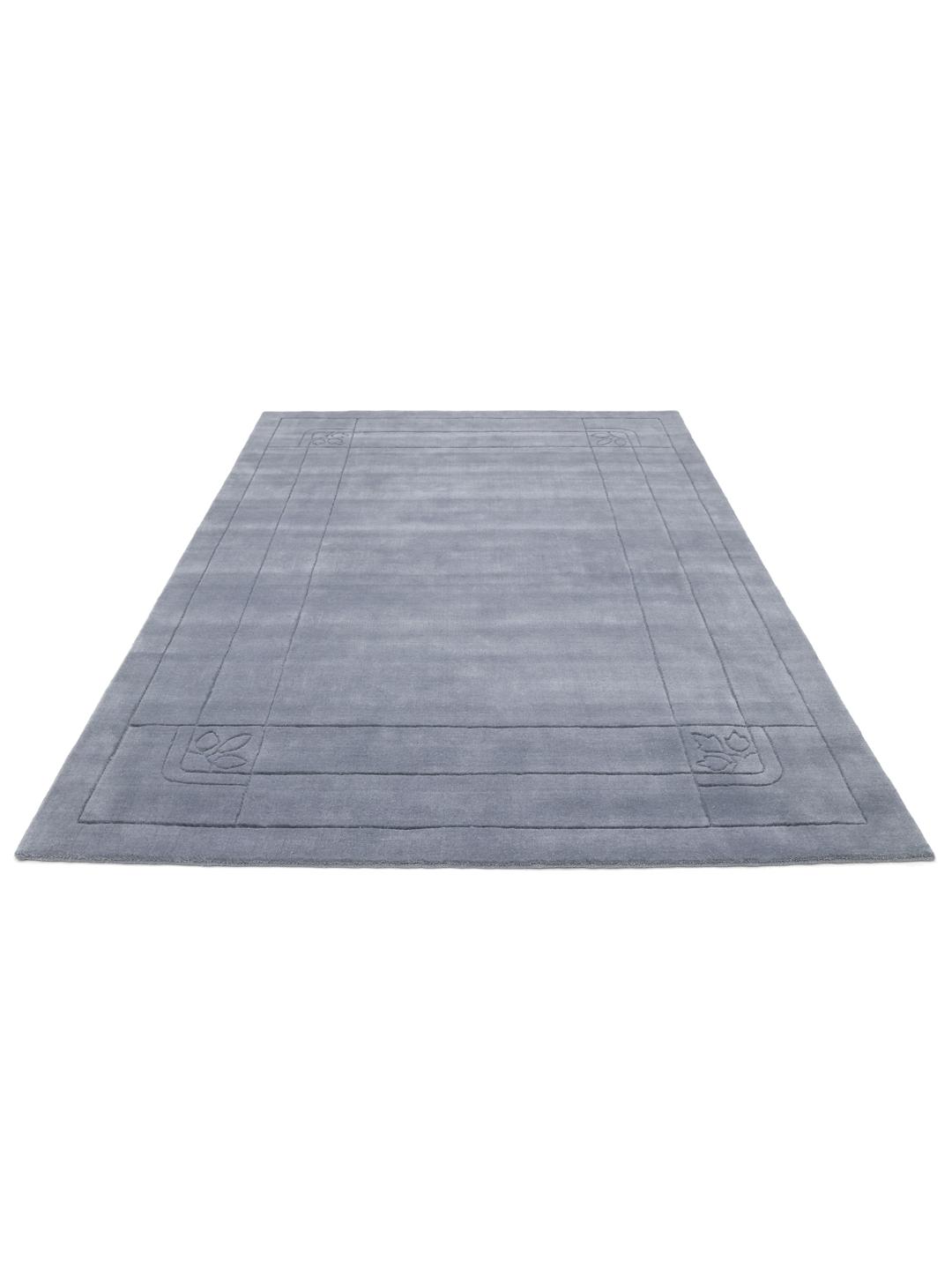 Een zacht blauw tapijt met een decoratieve rand.