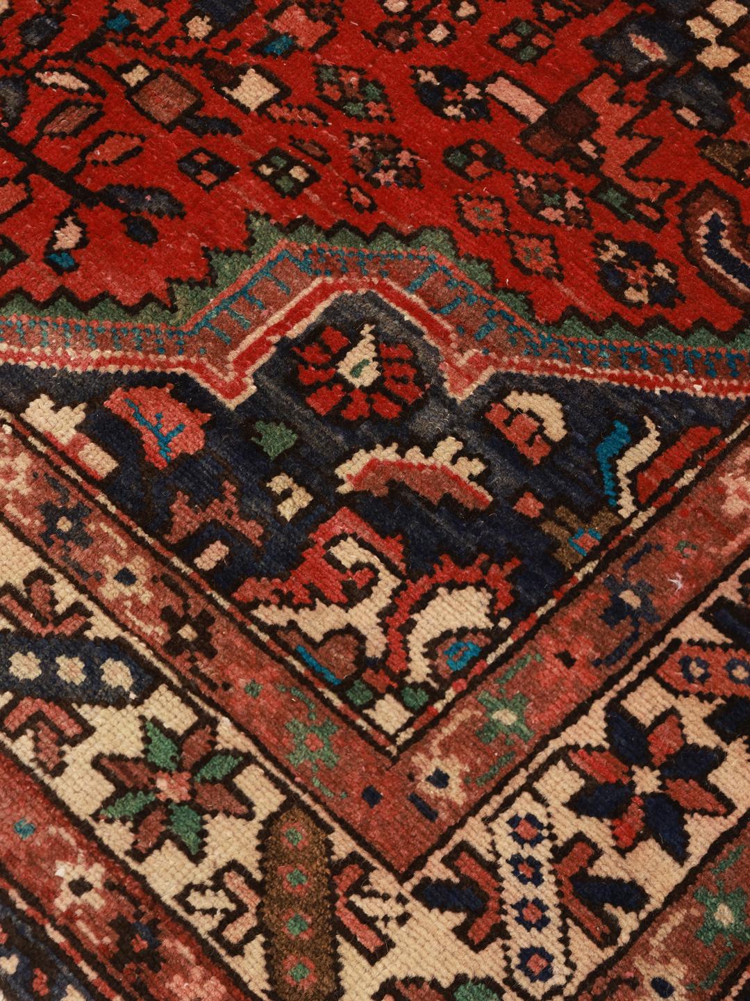Hand-knotted Hamadan rug from the Middle East in dark-red