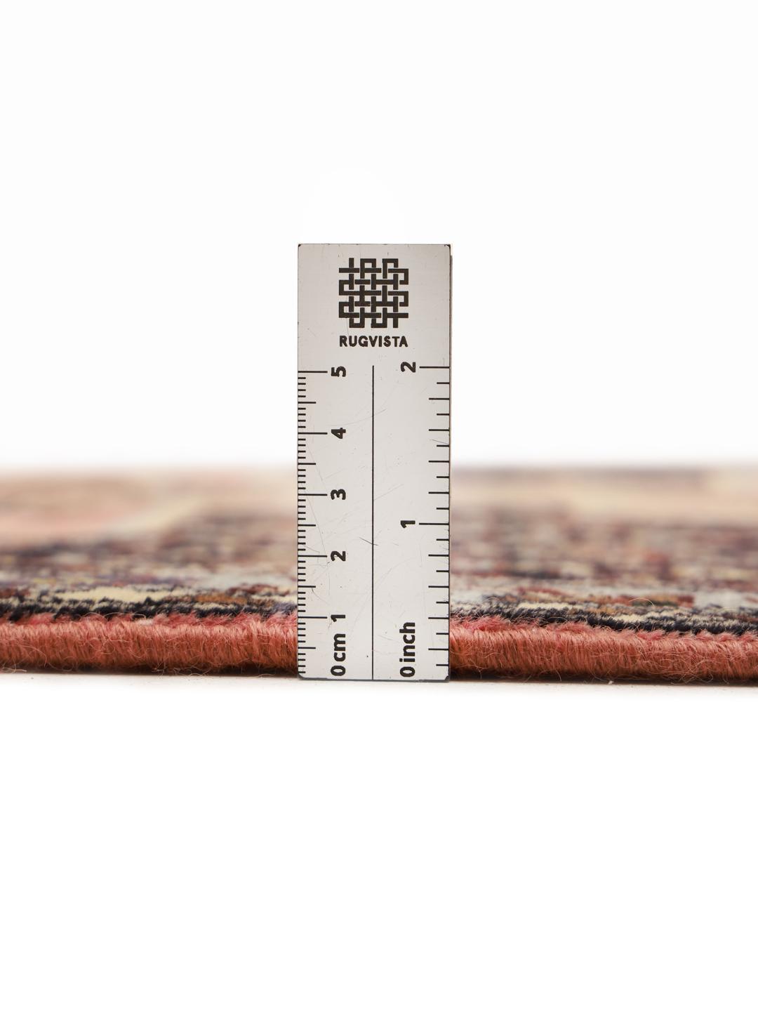 A hand-knotted Senneh runner with a multicolored diamond pattern on a dark field.