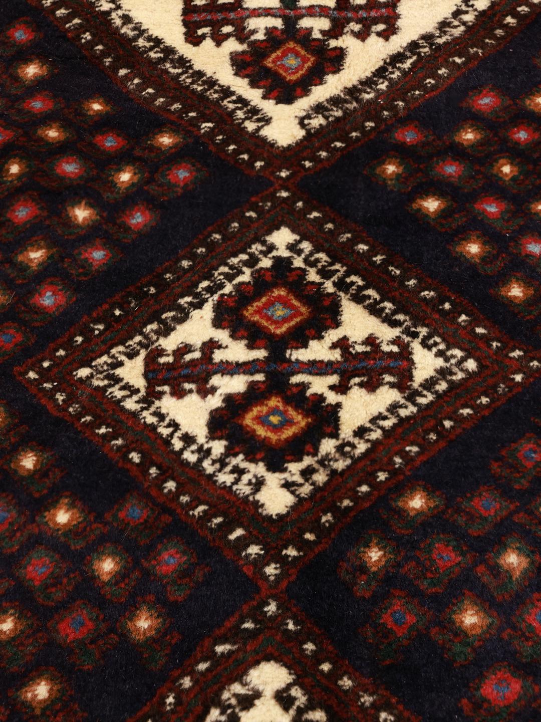 Hand-knotted Afshar Shahre Babak rug from the Middle East featuring a dark-red and black geometric pattern.