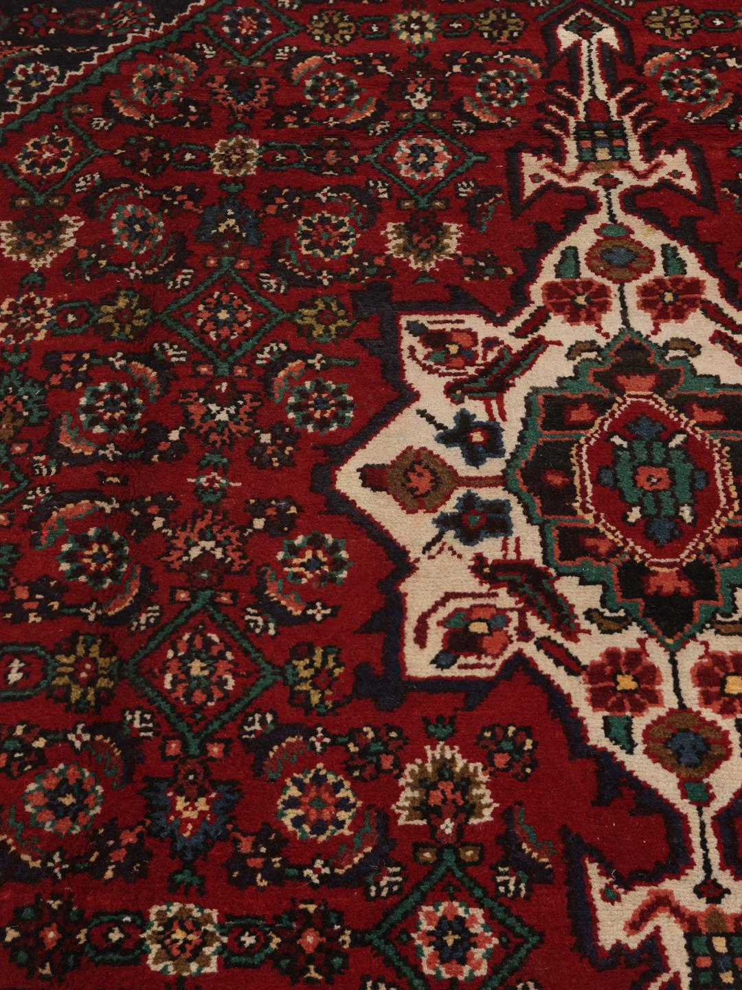 Hand-knotted Hosseinabad rug from the Middle East in deep red and blue tones