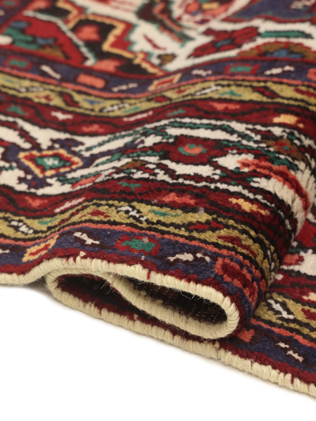 Hand-knotted Hosseinabad rug from the Middle East in deep red and blue tones