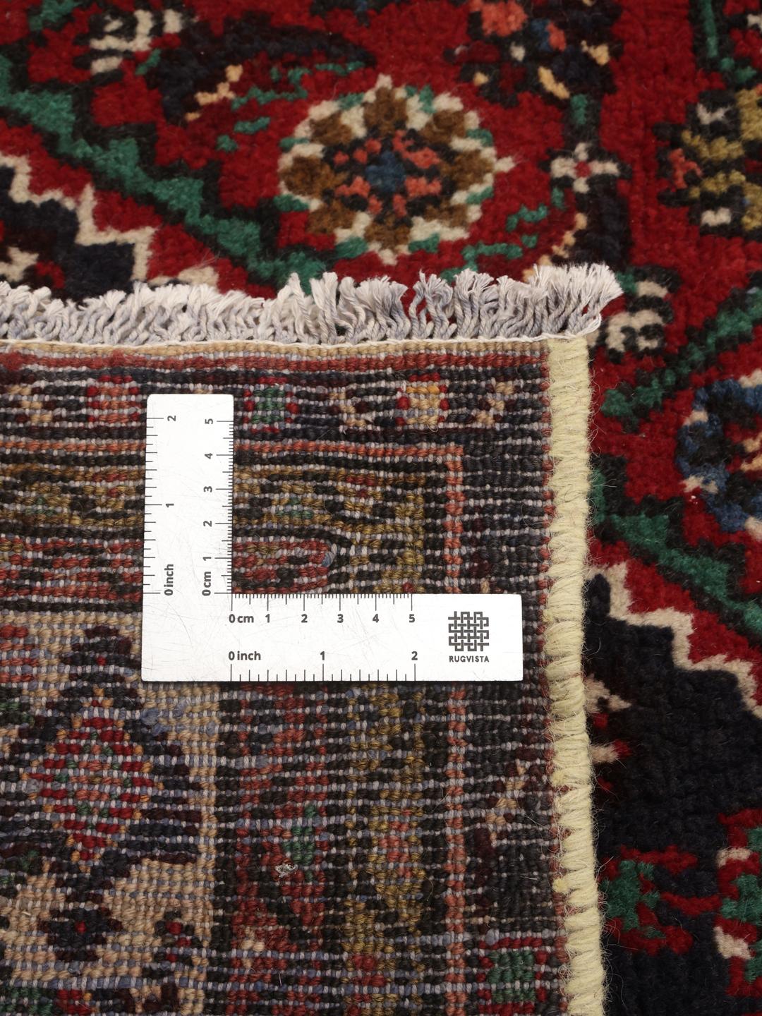 Hand-knotted Hosseinabad rug from the Middle East in deep red and blue tones