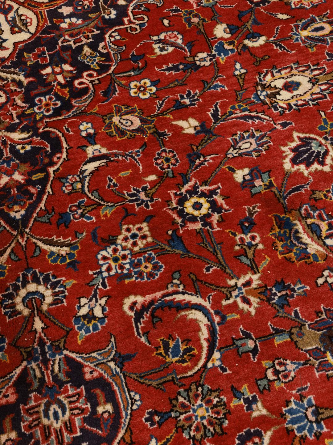 Hand-knotted Keshan rug from the Middle East in red and deep blue tones.