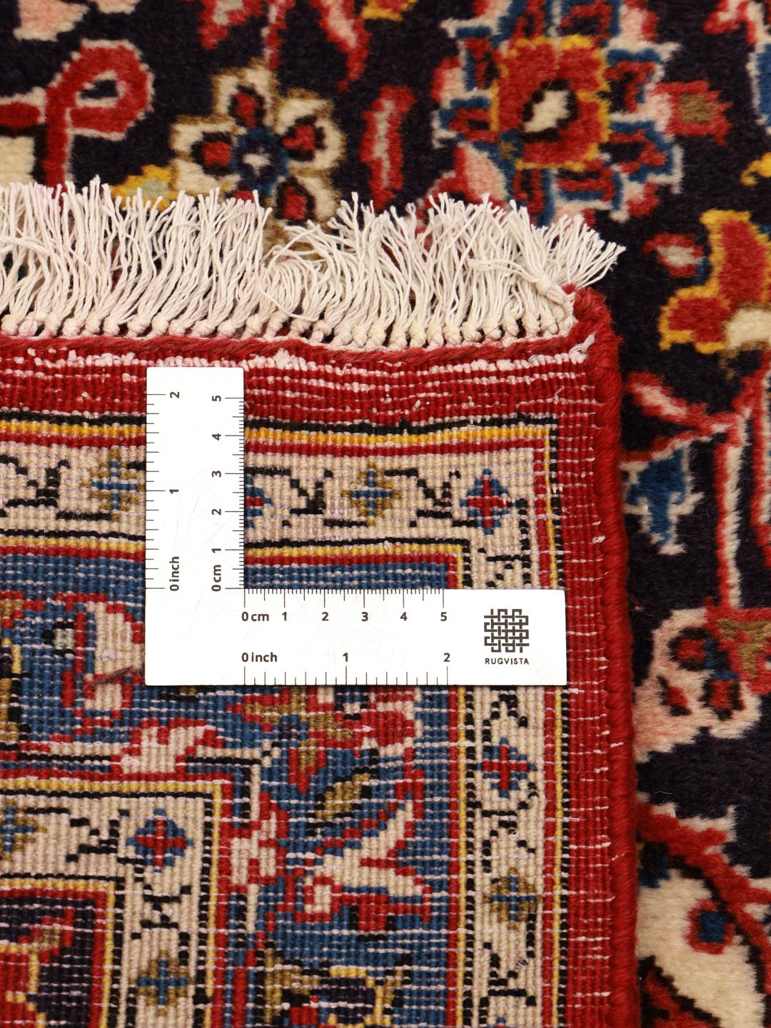 Hand-knotted Keshan rug from the Middle East in red and deep blue tones.