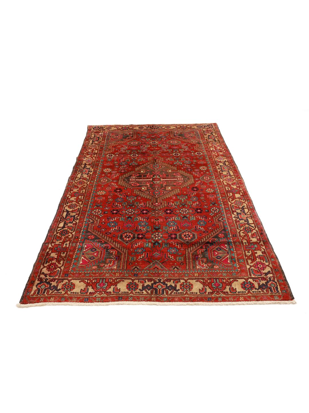 A vibrant hand-knotted rug from the Middle East with a deep red field and ornate tribal motifs.