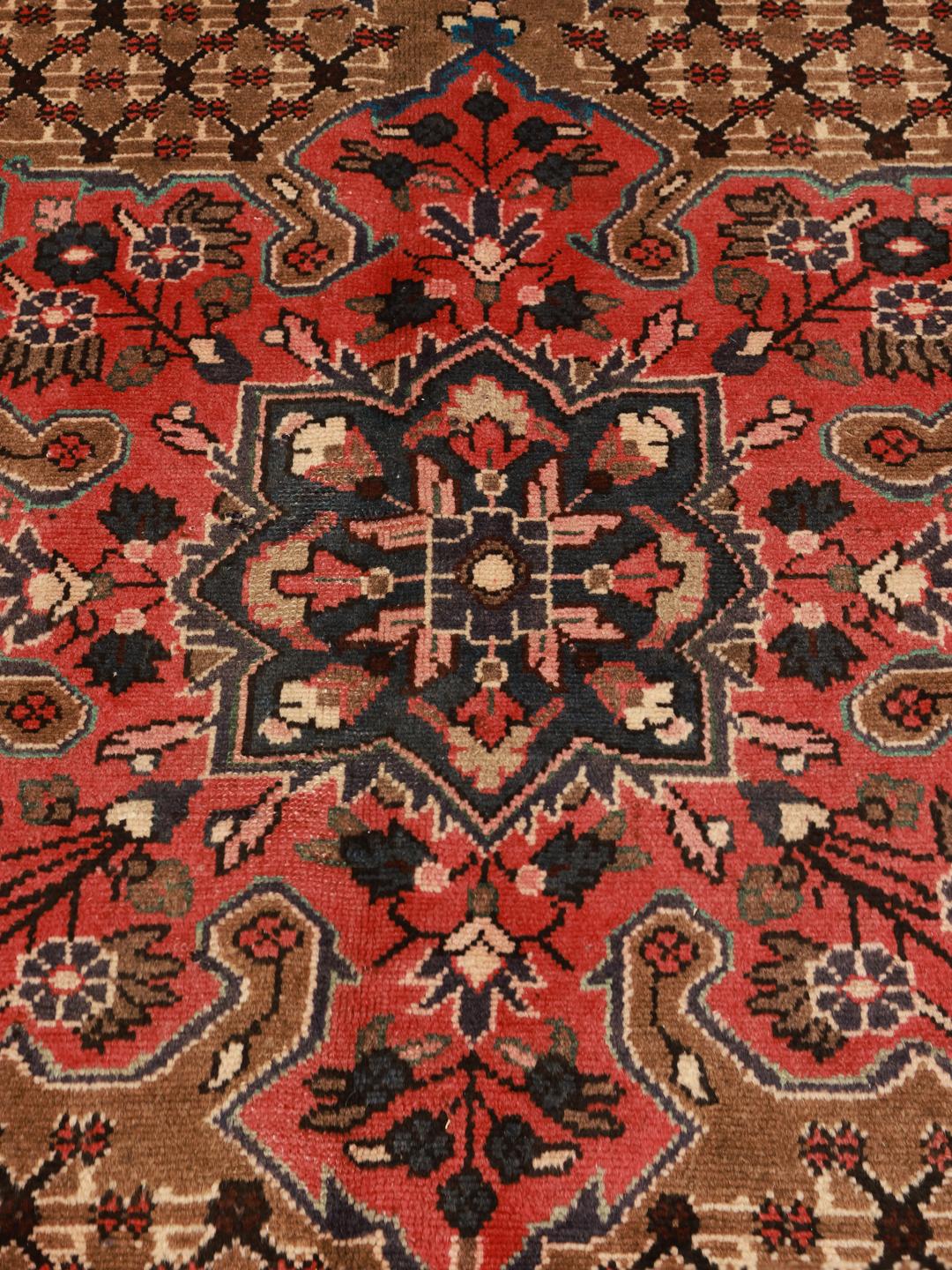 A unique hand-knotted Koliai rug from the Middle East in brown and red tones.