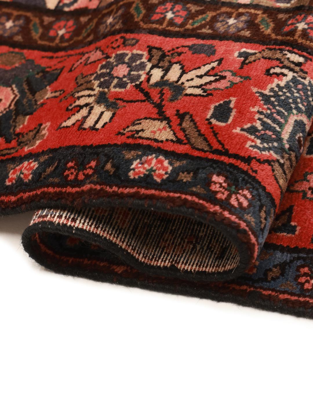 A unique hand-knotted Koliai rug from the Middle East in brown and red tones.
