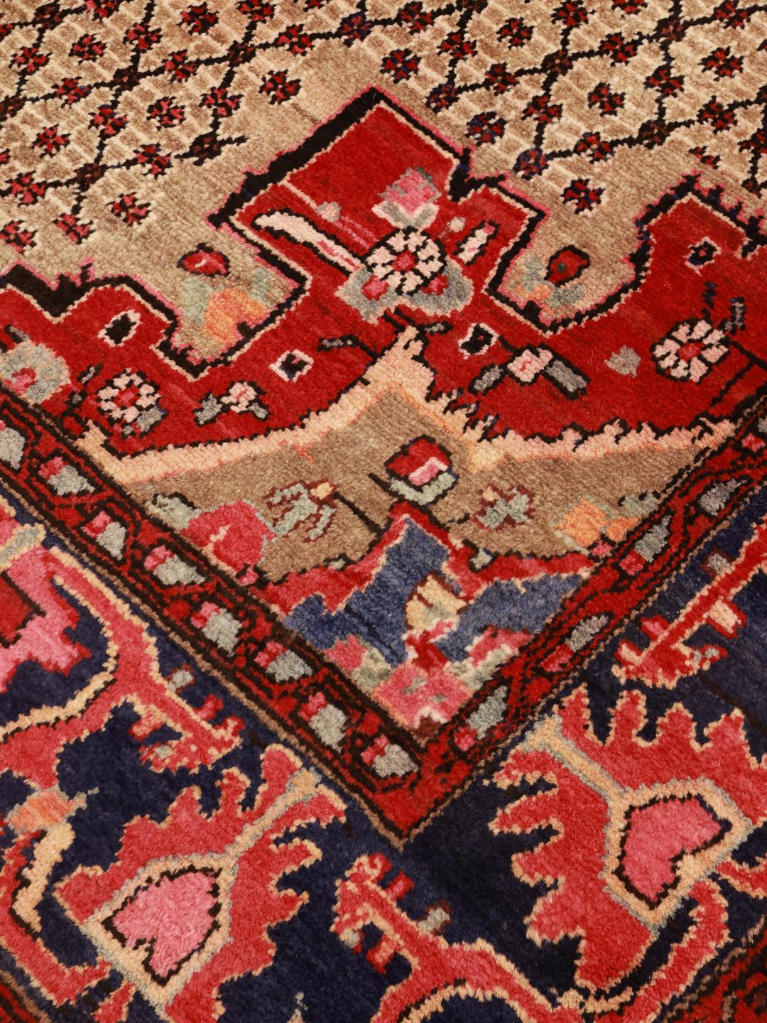 A hand-knotted Koliai rug from the Middle East with a multicolor geometric design.