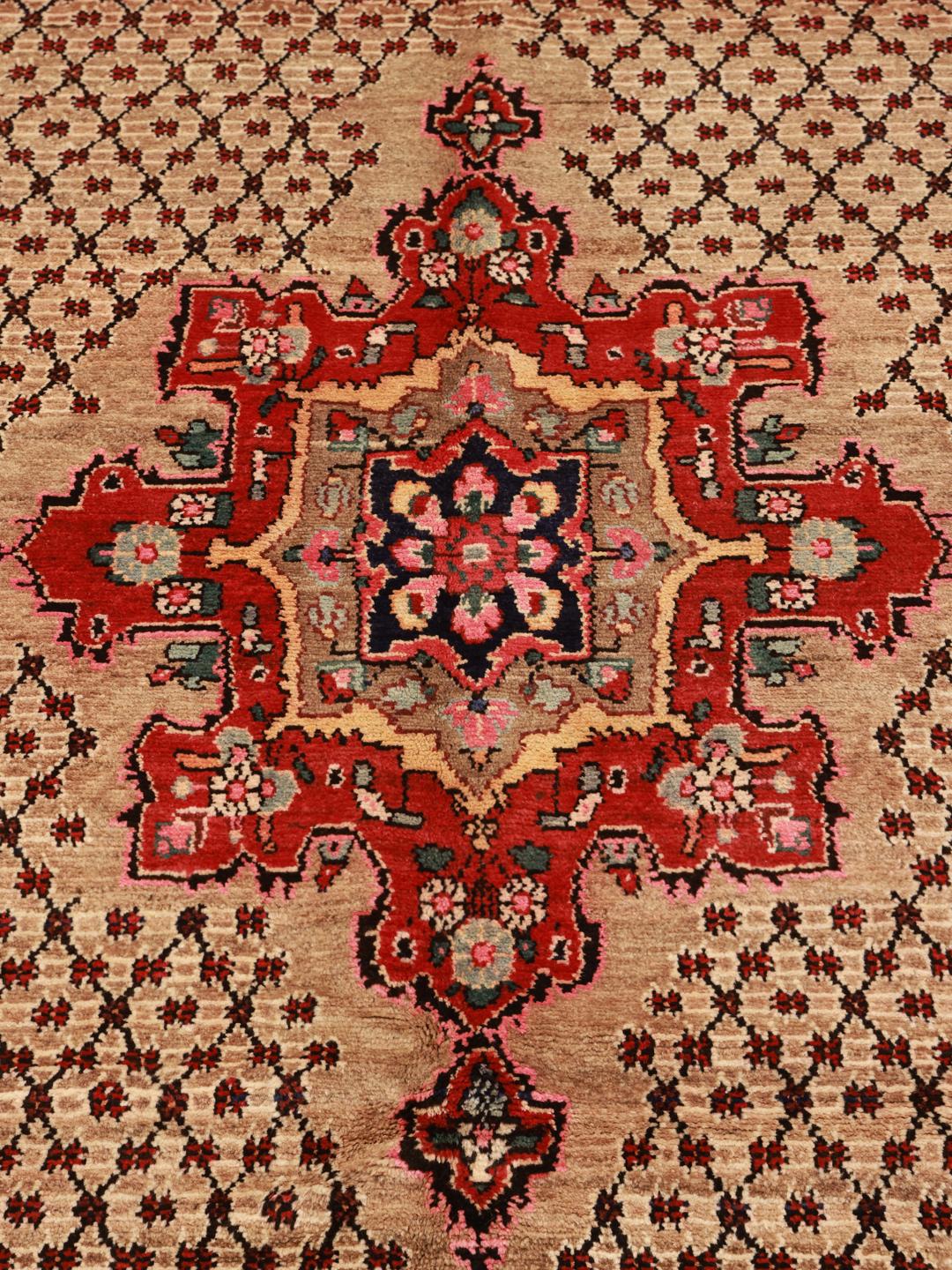A hand-knotted Koliai rug from the Middle East with a multicolor geometric design.