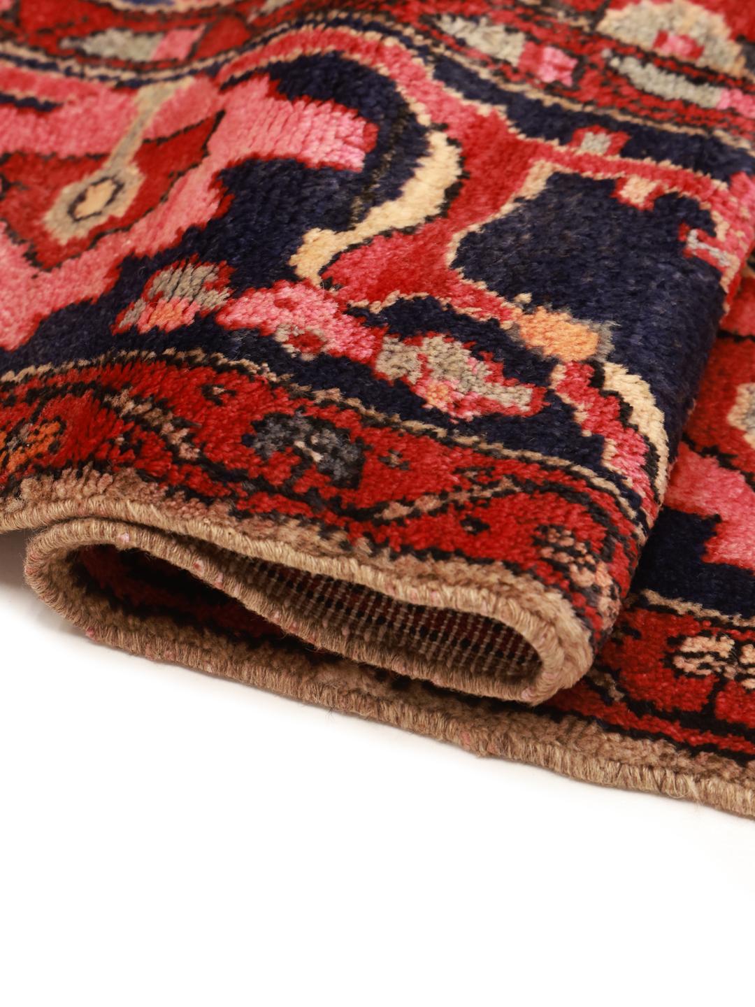 A hand-knotted Koliai rug from the Middle East with a multicolor geometric design.