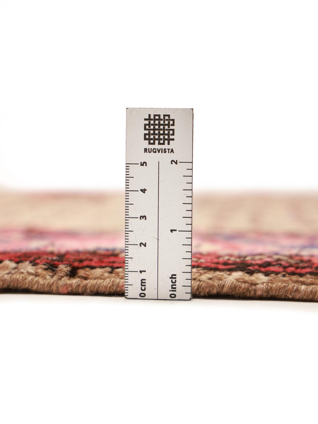 A hand-knotted Koliai rug from the Middle East with a multicolor geometric design.