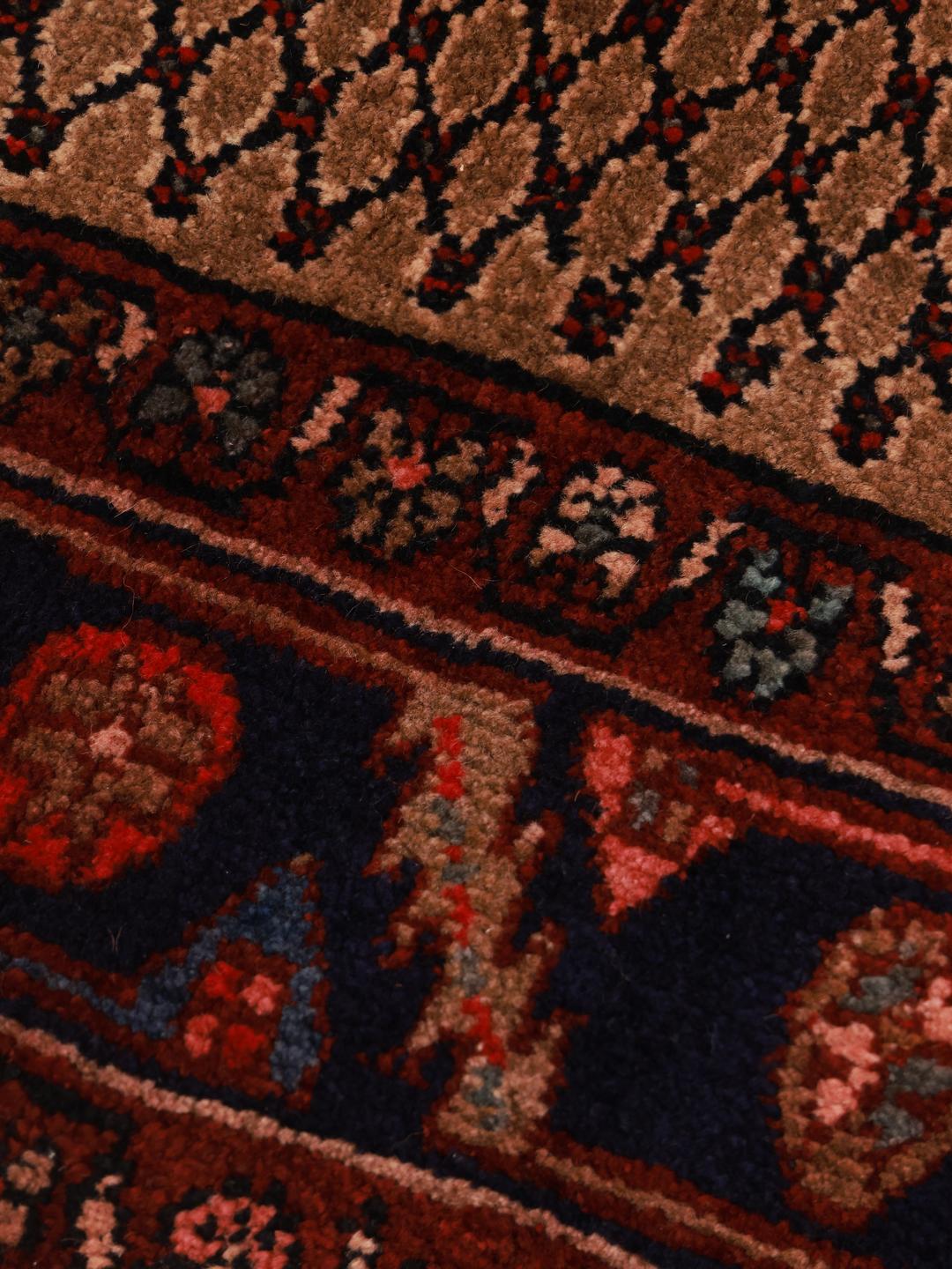 Hand-knotted Middle Eastern Koliai rug in shades of brown and red