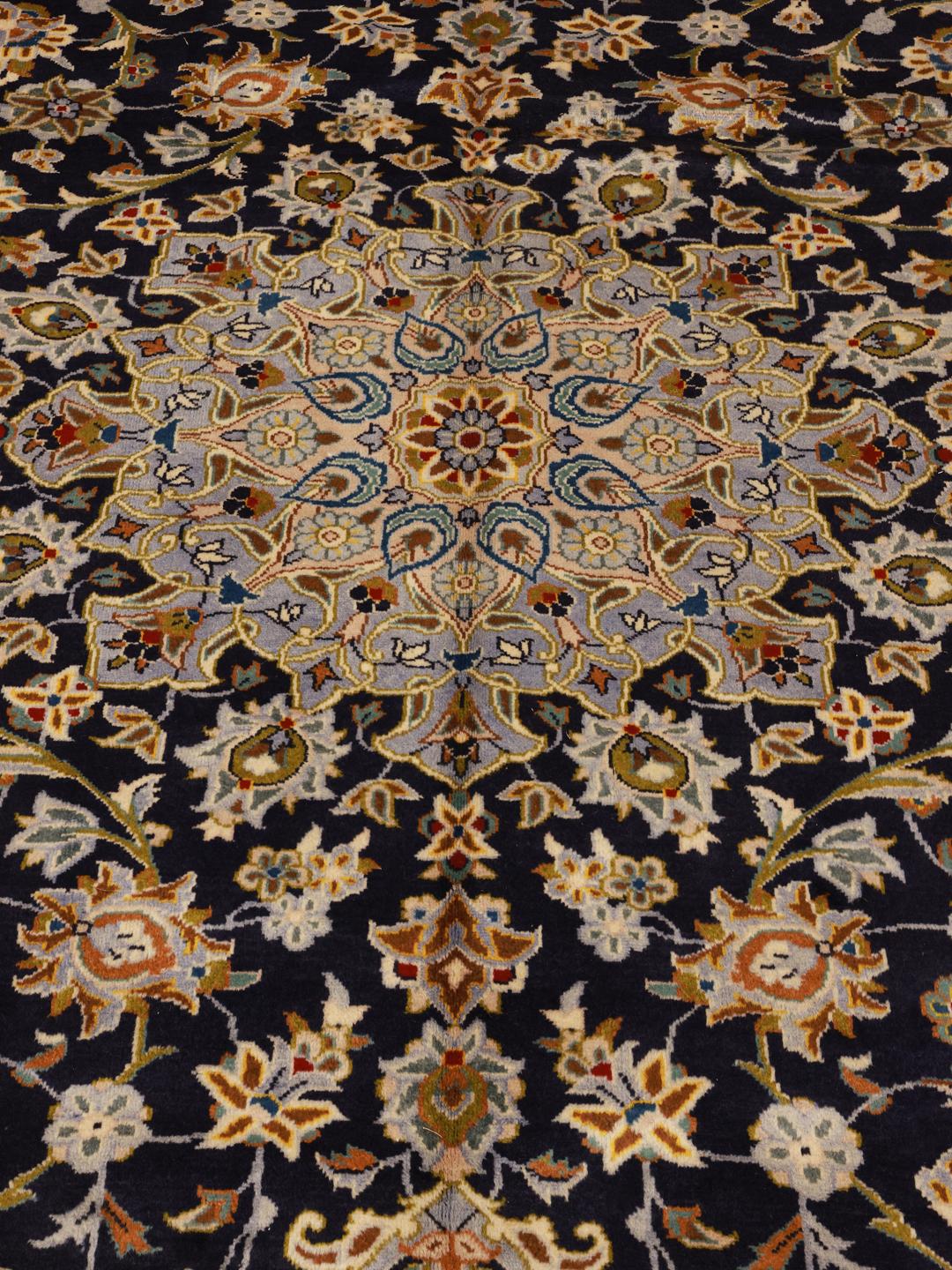 Hand-knotted Keshan rug from the Middle East in dark blue with intricate floral patterns