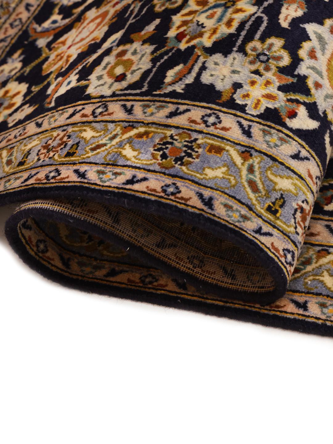 Hand-knotted Keshan rug from the Middle East in dark blue with intricate floral patterns