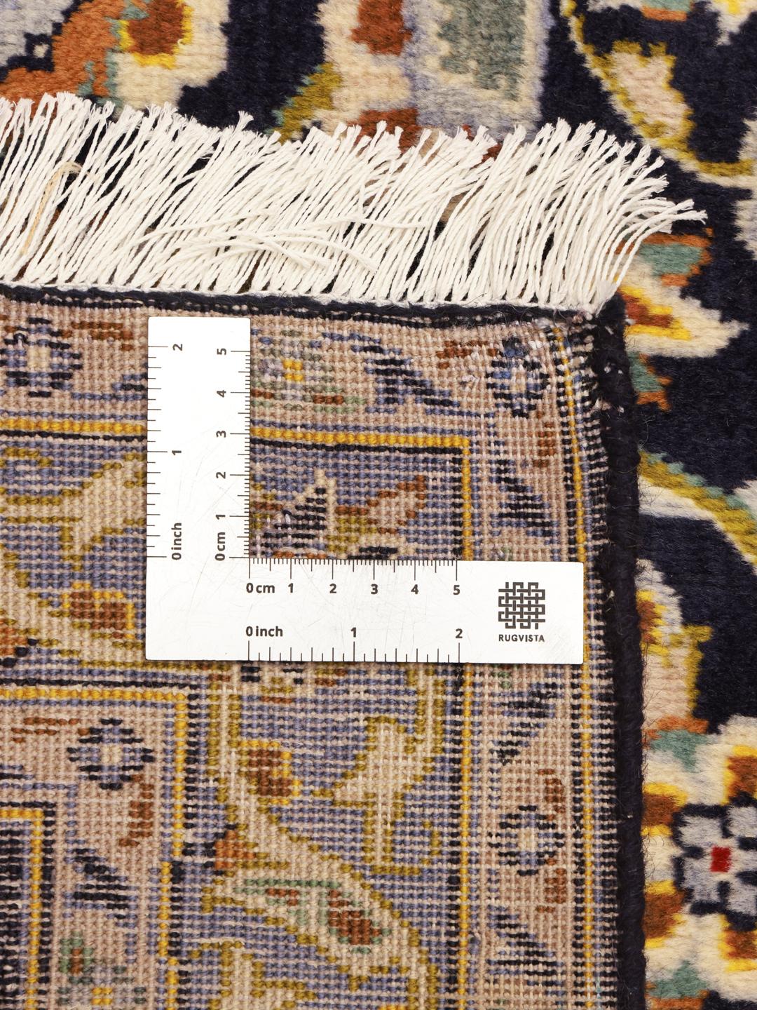 Hand-knotted Keshan rug from the Middle East in dark blue with intricate floral patterns
