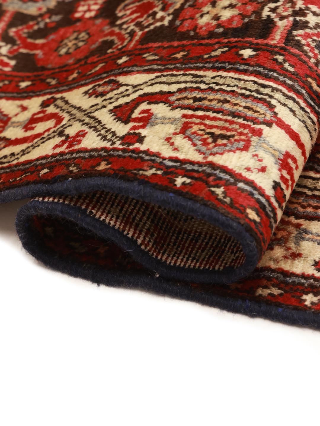 A long, hand-knotted Hamadan runner with a dark-red and cream floral pattern.