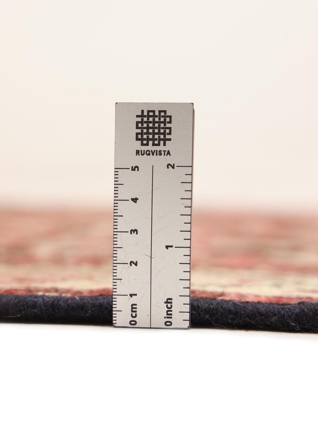 A long, hand-knotted Hamadan runner with a dark-red and cream floral pattern.