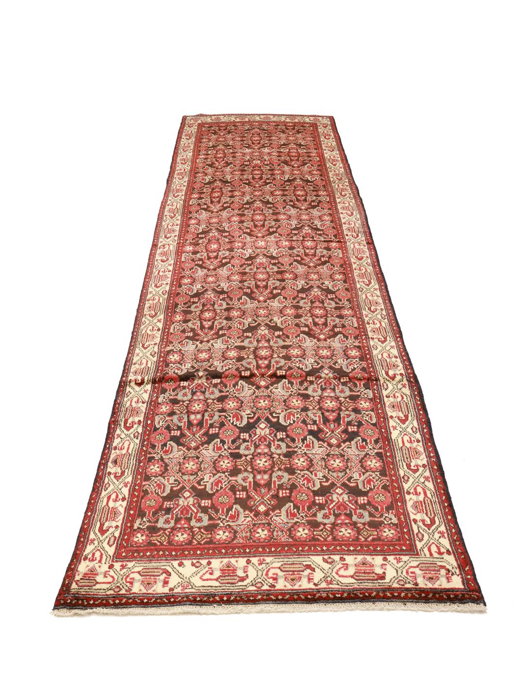 A long, hand-knotted Hamadan runner with a dark-red and cream floral pattern.