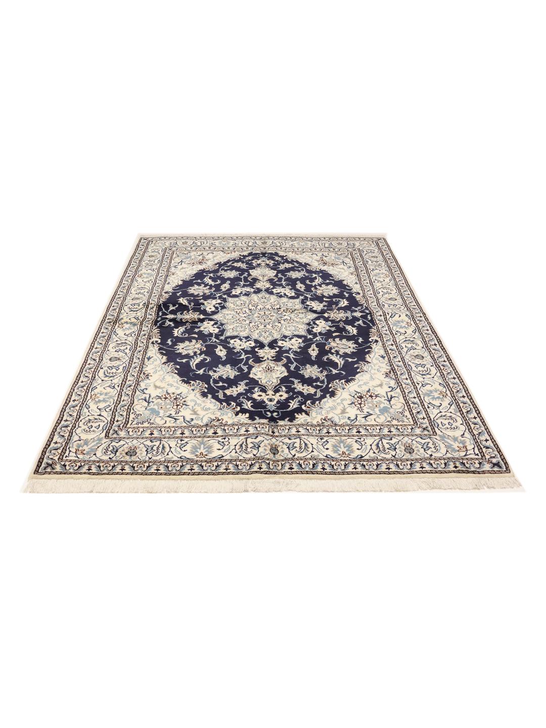 A hand-knotted rug from the Middle East with a dark-blue field and floral patterns.