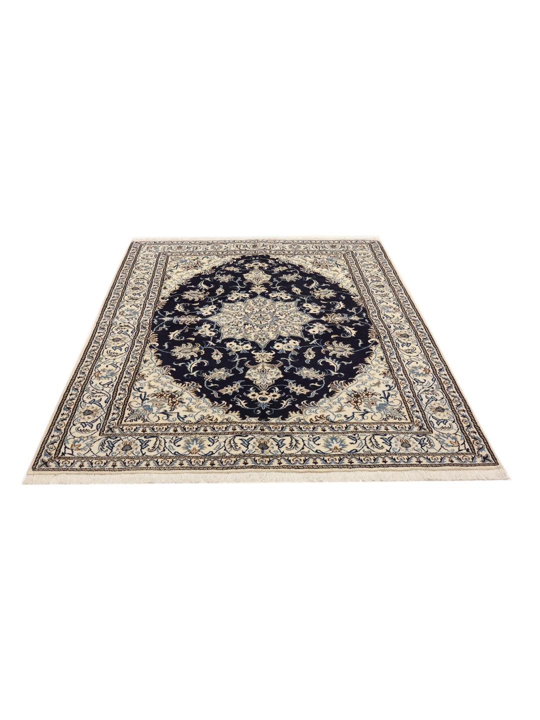 A hand-knotted rug from the Middle East with a dark-blue field and floral patterns.