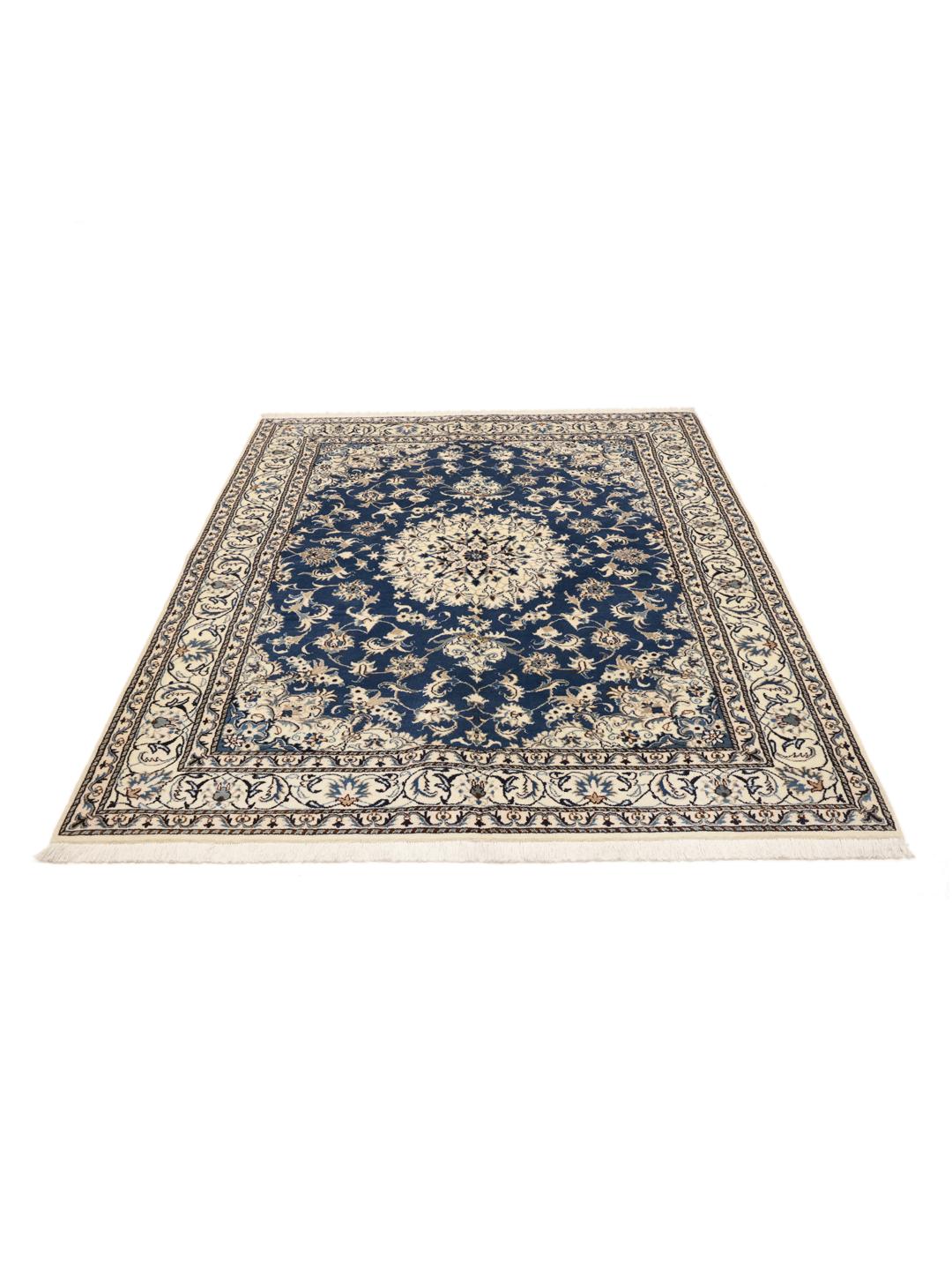 A hand-knotted Nain rug from the Middle East featuring a deep blue field with floral patterns.