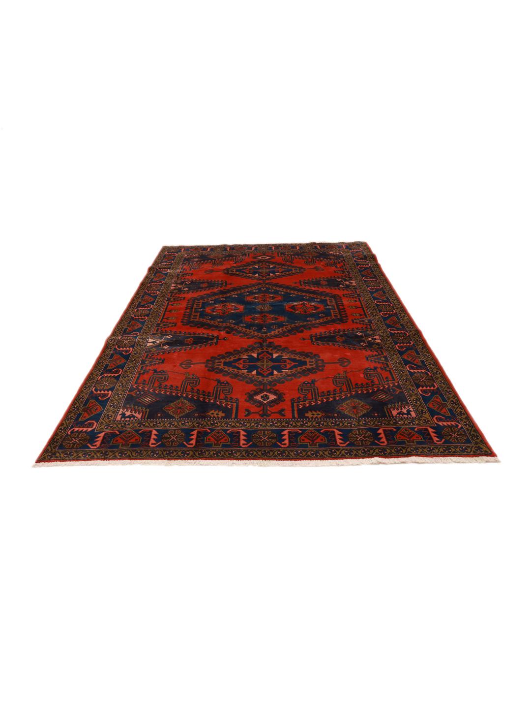 Een handgeknoopt Wiss-tapijt uit het Midden-Oosten met een gedurfd rood en blauw geometrisch patroon.