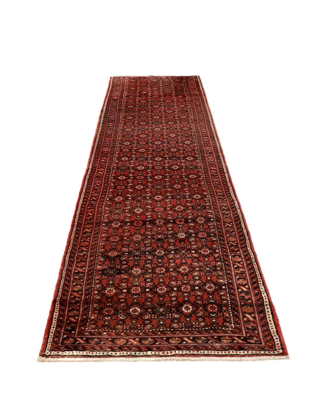 Hand-knotted Hosseinabad runner from the Middle East in deep red tones