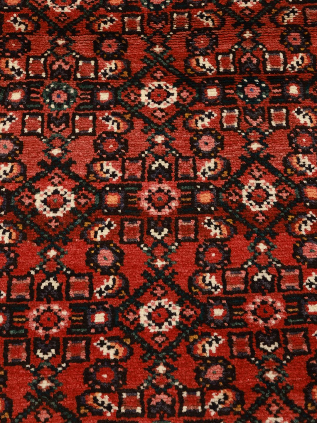 Hand-knotted Hosseinabad runner from the Middle East in deep red tones
