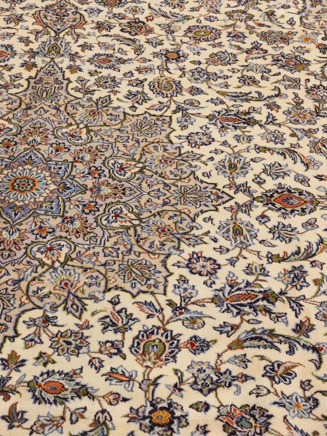 Hand-knotted Keshan rug from the Middle East featuring a floral medallion on a beige field