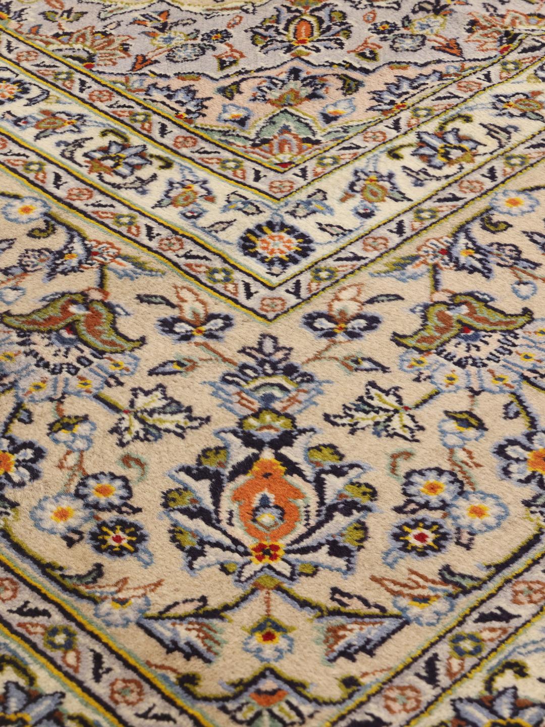 Hand-knotted Keshan rug from the Middle East featuring a floral medallion on a beige field