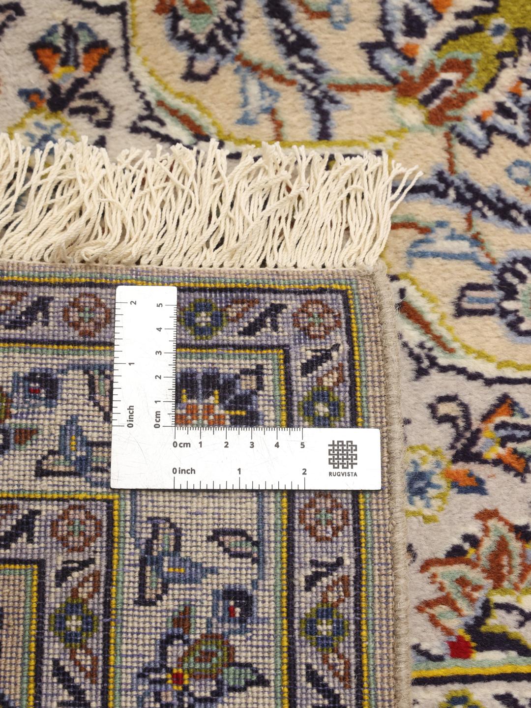 Hand-knotted Keshan rug from the Middle East featuring a floral medallion on a beige field