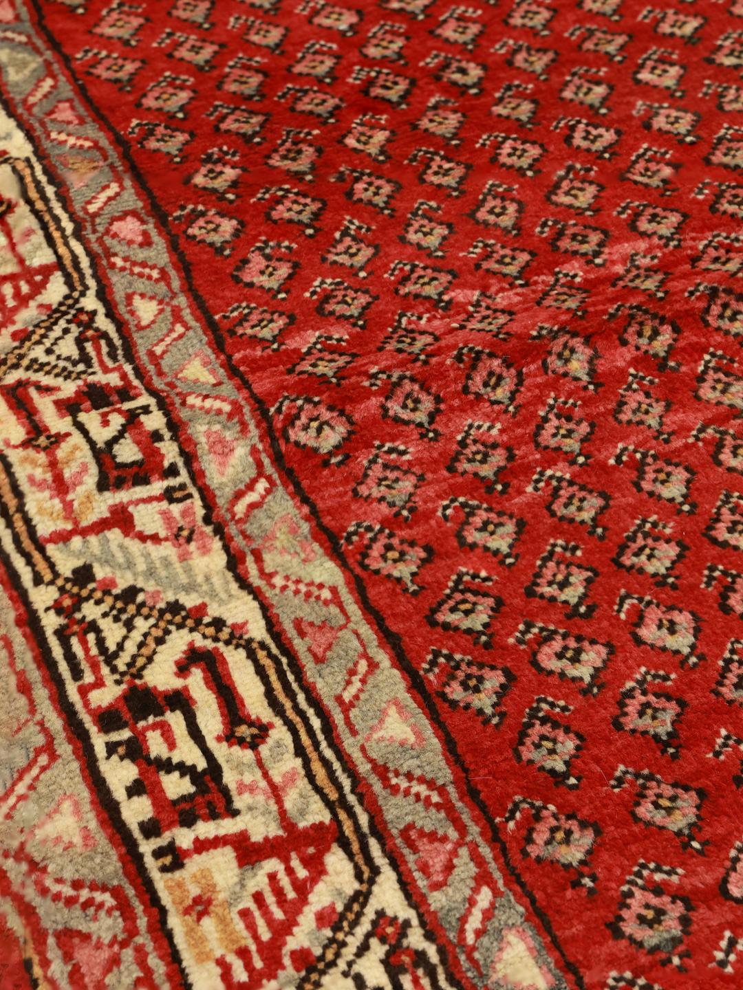 A hand-knotted red Hamadan runner with traditional geometric patterns from the Middle East