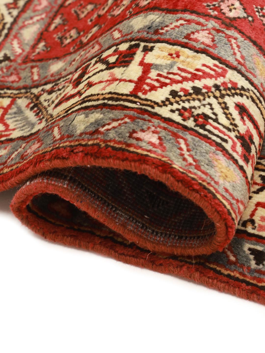 A hand-knotted red Hamadan runner with traditional geometric patterns from the Middle East