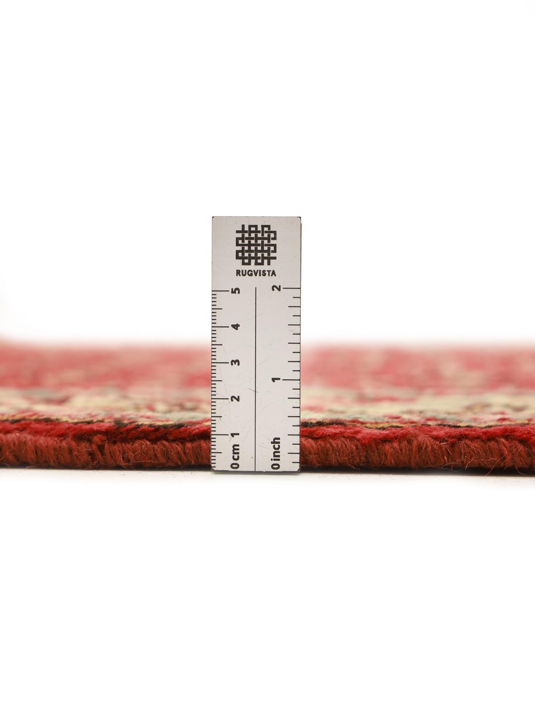A hand-knotted red Hamadan runner with traditional geometric patterns from the Middle East
