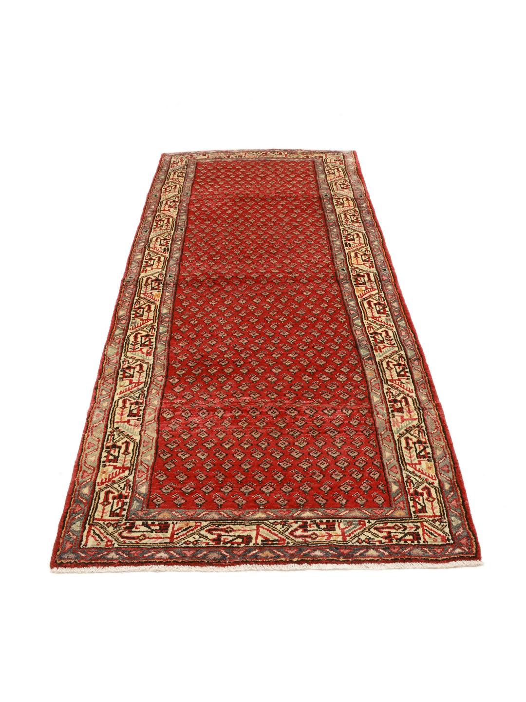 A hand-knotted red Hamadan runner with traditional geometric patterns from the Middle East