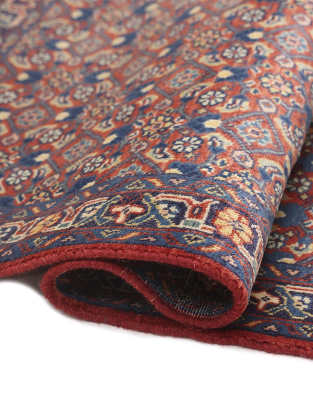 A hand-knotted Hamadan rug from the Middle East featuring blue and red tones.