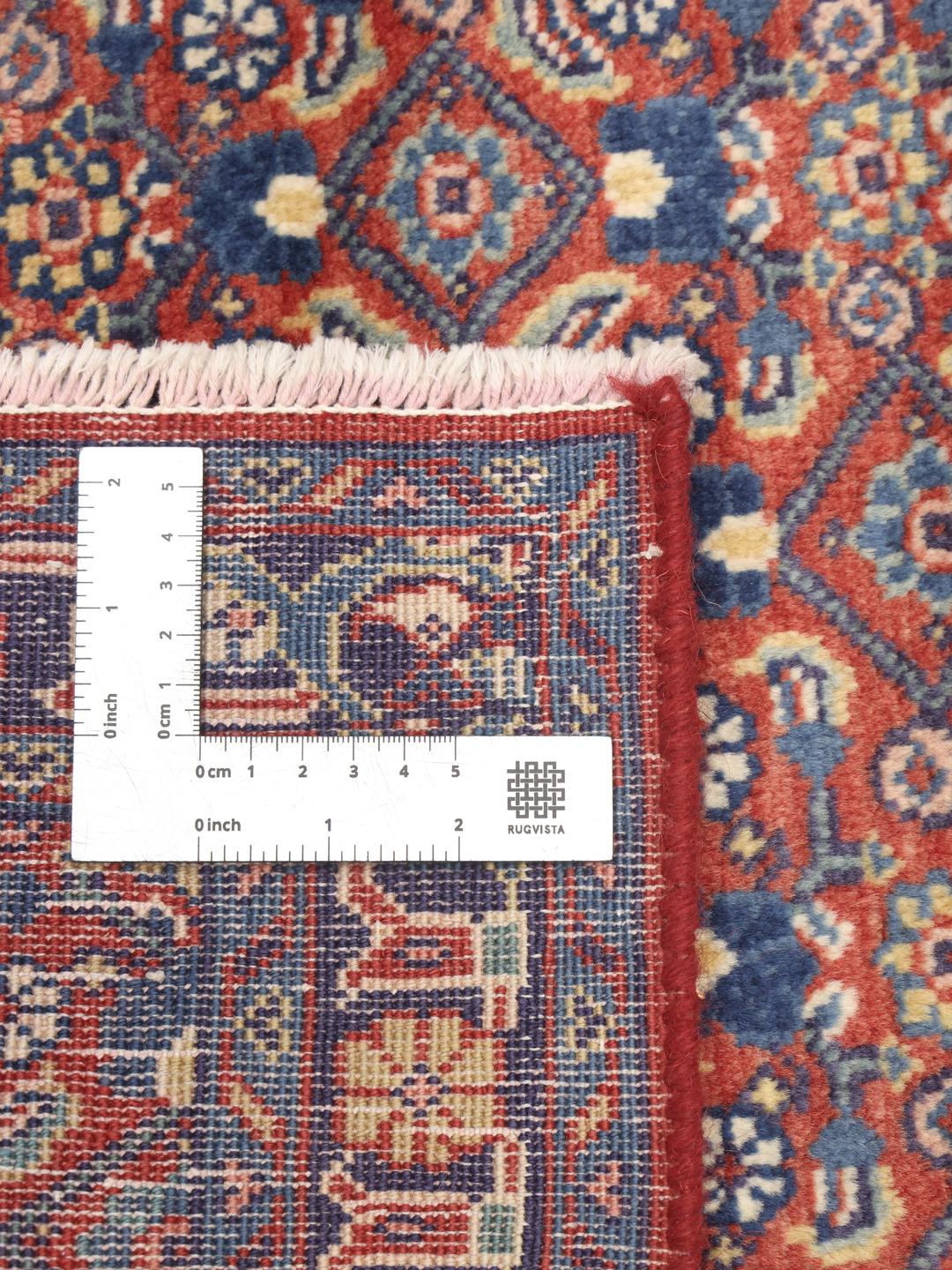 A hand-knotted Hamadan rug from the Middle East featuring blue and red tones.
