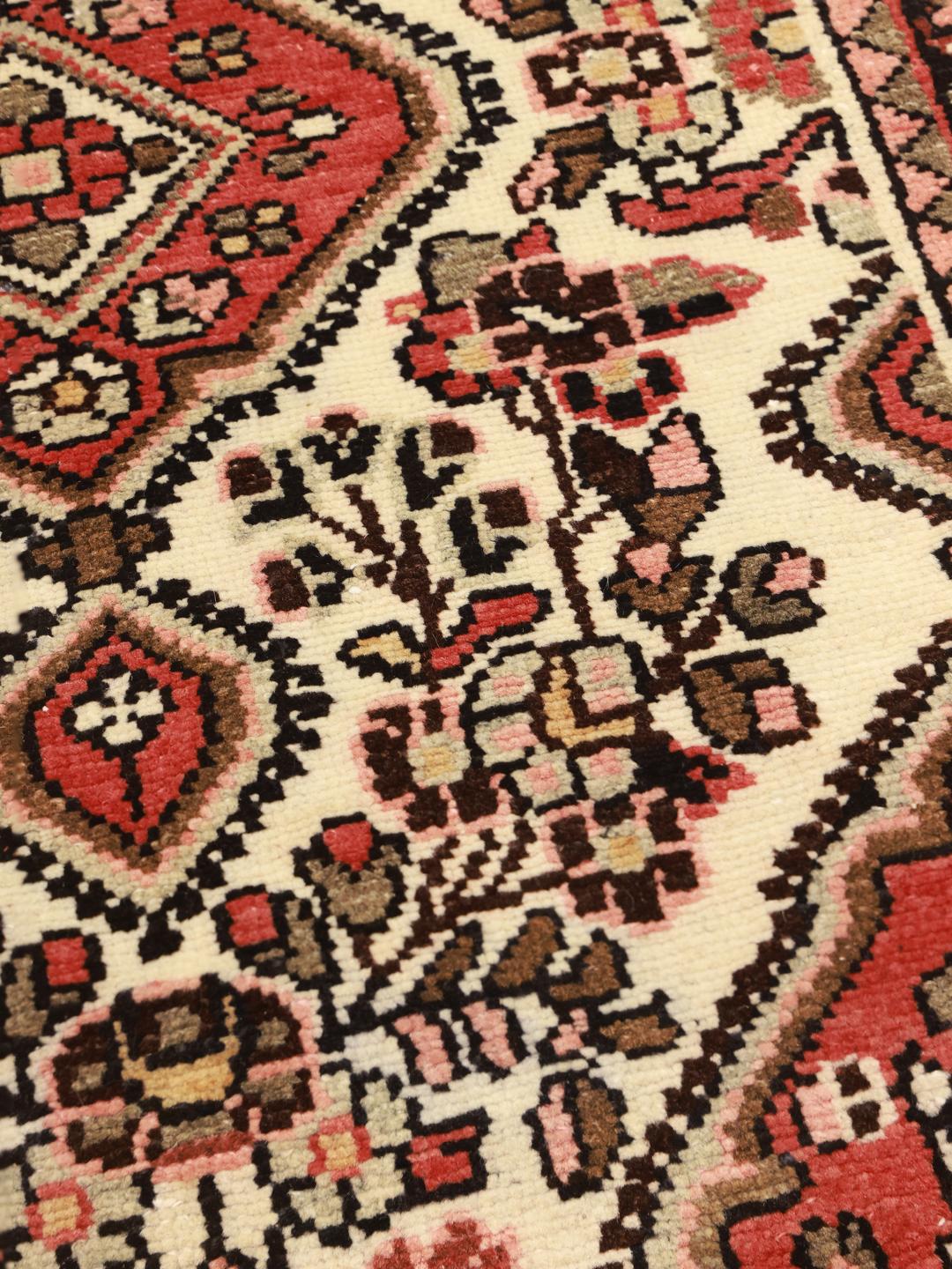 Hand-knotted Middle Eastern Hamadan rug with a red and beige floral medallion